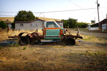 Old rusted and dilapidated truck in field