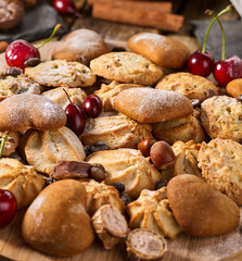 Oatmeal Cookies and sand chocolate cake with nut on wooden table in farm style close up. Easily digestible and quickly digestible substances.