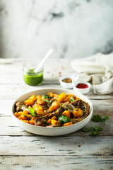 Beef on the bone with pumpkin and pesto
