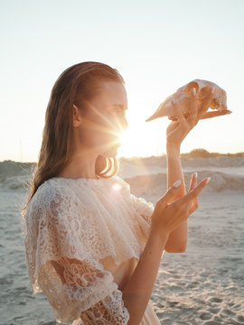 Anonymous woman looking at skull