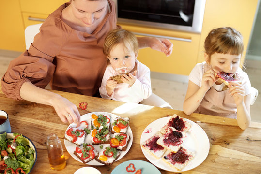 Naklejki Girls Having Snack With Mom