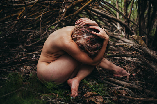 Naked woman sitting outdoors