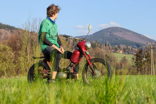 Fan of motorbikes sits on renovated jawa pioneer and enjoy view on Beskydy mountains in Czech republic. Type of motorcycles who rode mainly in czech republic. Fichtl, pincek, fechtl. Motor vehicle