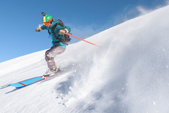 Freeride skier on fresh powder snow