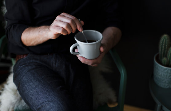 Man drinking coffee at home