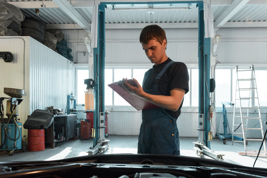 Garage worker taking notes