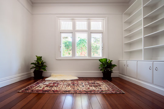 Empty white bookcase in an empty white room