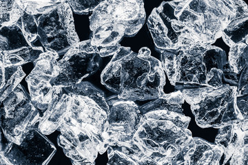 Pieces of crushed ice cubes on black background. 