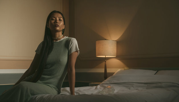 Elegant young model in stylish dress .