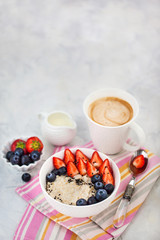 Healthy breakfast with oatmeal porridge, fresh berries and coffee
