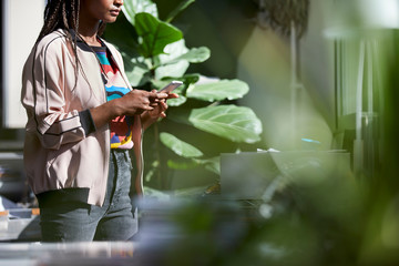 Midsection Of Businesswoman Using Phone In Office