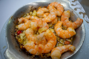 Tiger Prawns Fried on butter with garlic and chili. Served on silver metal plate in restaurant. Traditional Portuguese food 