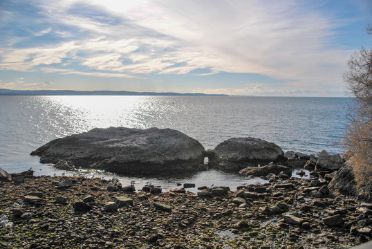 pebbles and rocks on he sea with clouds