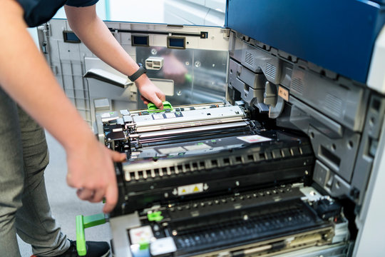 Close-up of teenager working at color printer