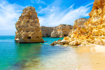 Praia de Marinha most beautiful beach in Algarve Portugal. beautiful landscape clear green and blue water cliffs and rock formations on Coast of Atlantic Ocean
