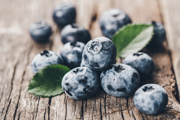 Freshly picked blueberries on wooden background. Healthy eating and nutrition.