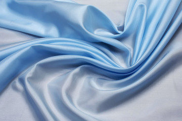 Fabric rayon light blue in the artistic layout. Texture, background, pattern.
