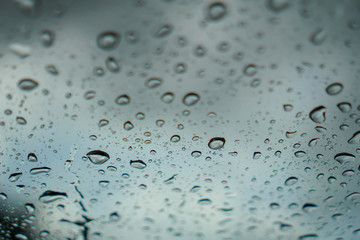 blur backgruond,Rain water on the car glass.