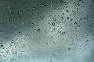blur backgruond,Rain water on the car glass.