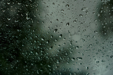 blur backgruond,Rain water on the car glass.