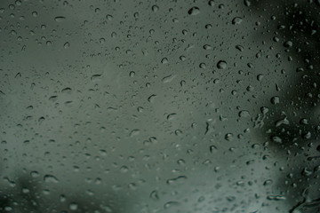 blur backgruond,Rain water on the car glass.