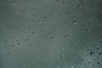 blur backgruond,Rain water on the car glass.