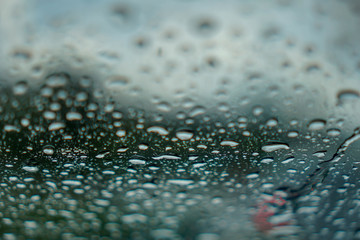 blur backgruond,Rain water on the car glass.