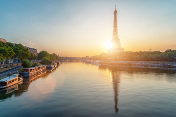 Eiffel Tower reflection on river Seine while sunrise