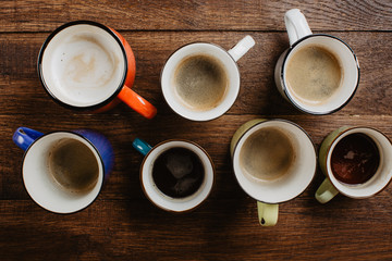 various mugs of coffee, wooden table, top view