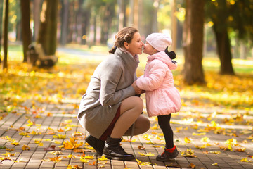 Fototapeta premium Family. Mother and daughter in autumn park. Mother with kid in outdoor