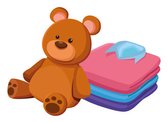 teddy bear toy and folded clothes