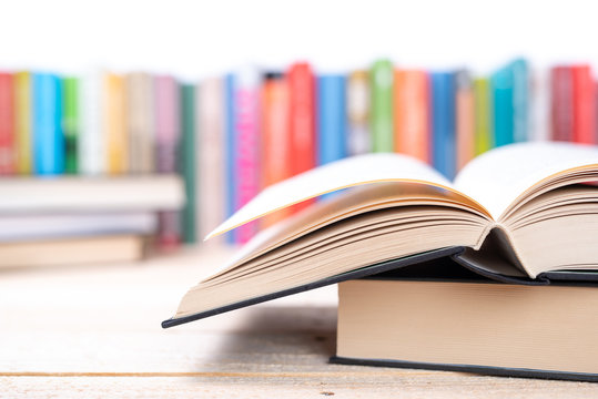 Close-up open book with library bookshelf toned background