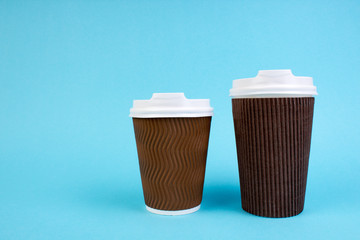 Two disposable paper cups of coffee, tea isolated on white background with copy space.