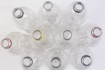 collection of empty used plastic bottles on white background.
