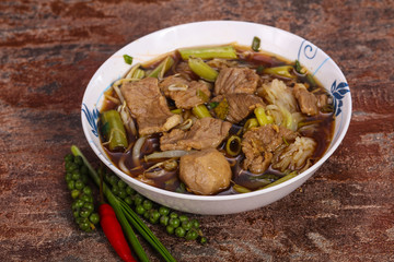 Thai style soup with meat and mushrooms