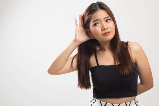 Beautiful young Asian woman listen to something.