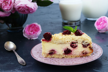 Cottage cheese pie with cherries on a dark background, piece of cake is located in the foreground on a plate