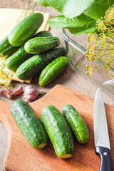 Fresh cucumbers on wooden board prepared for pickling