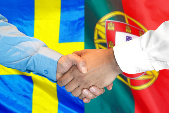 Business handshake on the background of two flags. Men handshake on the background of the Portugal and Sweden flag. Support concept