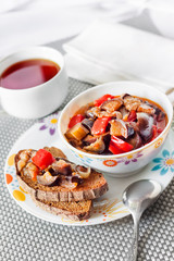 Vegetable stew with eggplant, red pepper and tomatoes on toasted rye bread