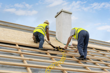 Building construction process of new wooden roof on wood frame house