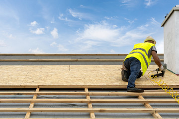 Building construction process of new wooden roof on wood frame house