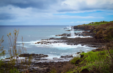 Rocky shoreline and Spouting Horn blowhole on the South Shore of Kauai near Poipu, Hawaii, USA