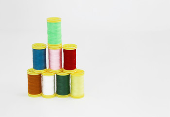 colorful threads for sewing or embroidery on a white background