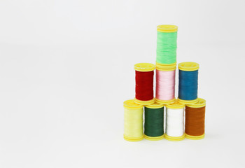 colorful threads for sewing or embroidery on a white background