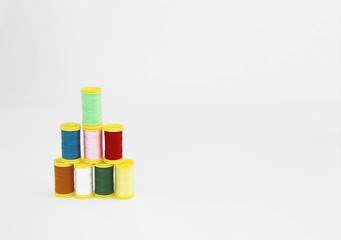 colorful threads for sewing or embroidery on a white background