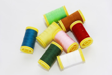 colorful threads for sewing or embroidery on a white background