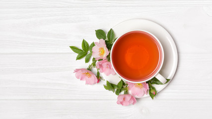 Top view on herbal tea with dog rose flowers for healthy life