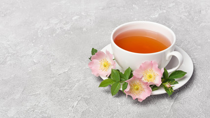 Obraz na płótnie Canvas Herbal tea with dog rose flowers for healthy life