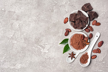 Top view on cocoa beans and powder with chocolate chunks for confectionery